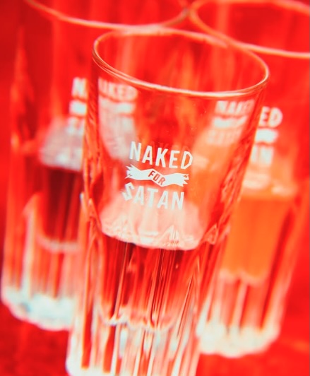 Rooftop view at Naked for Satan in Fitzroy featuring city skyline, outdoor seating, and colourful cocktails on the table