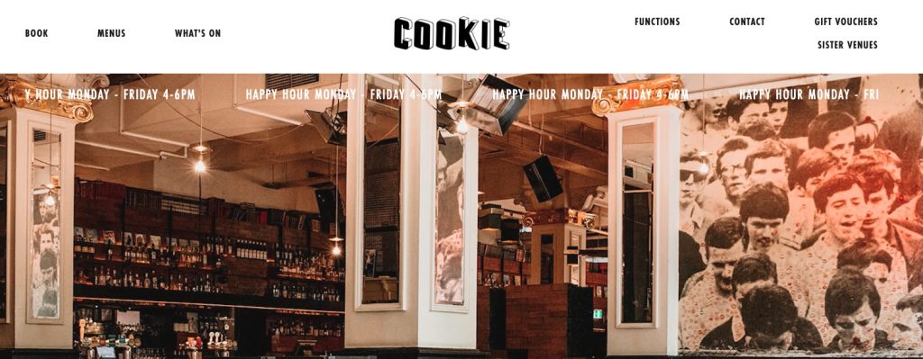 Interior of Cookie Bar Melbourne with warm lighting, vintage décor, and patrons enjoying cocktails at the bustling bar