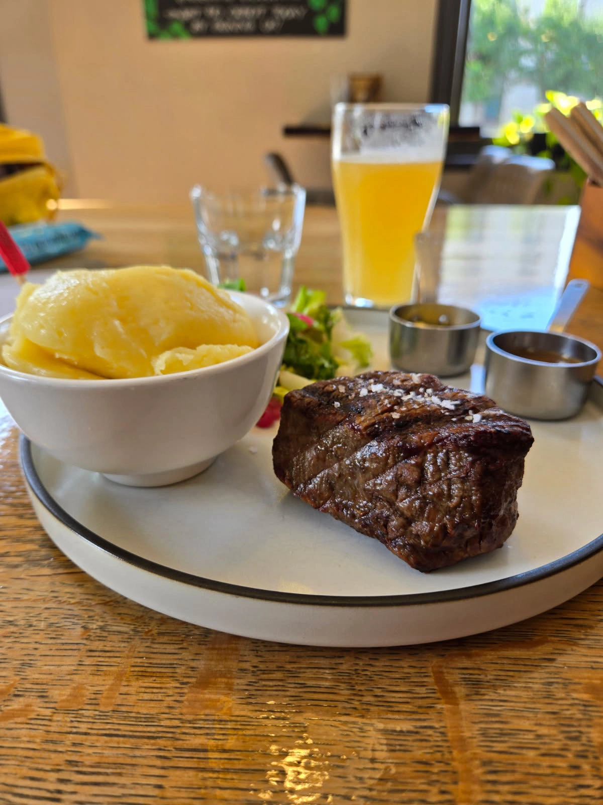 Porterhouse steak with roast potatoes, salad, and beer at The Station Hotel Footscray