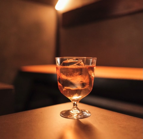 Minimalist interior of One or Two Melbourne with soft lighting, modern design, and a signature cocktail served on the counter