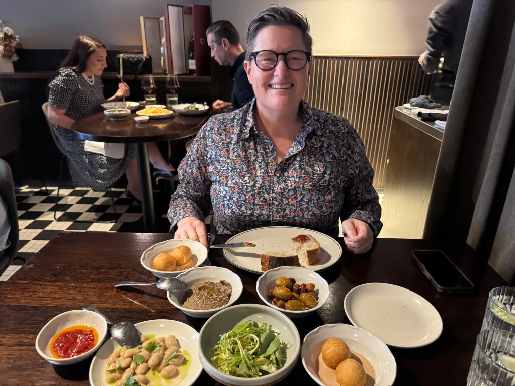 Maltese Feast dishes include fish, olives, dip, donuts at Maha East