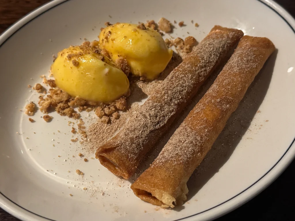 Mqaret dessert of pastry filled with dates, orange and star anise with ice cream at Maha East