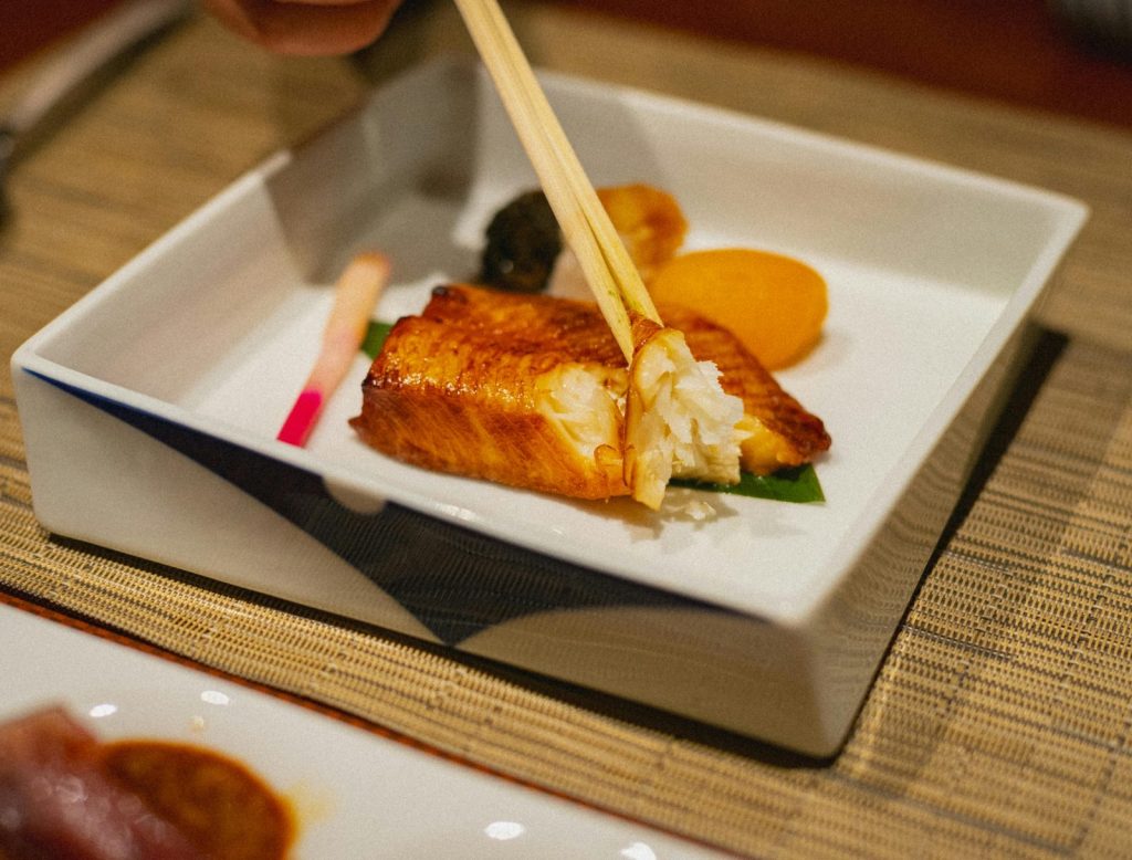 Elegant grilled fish dish with chopsticks in a Japanese restaurant in Kamogawa, Chiba.